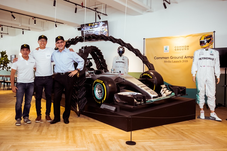 Petronas Dagangan Berhad (PDB) spokespeople and Common Ground spokesperson posing with the highly successful Mercedes-Benz Formula One racing car.jpg